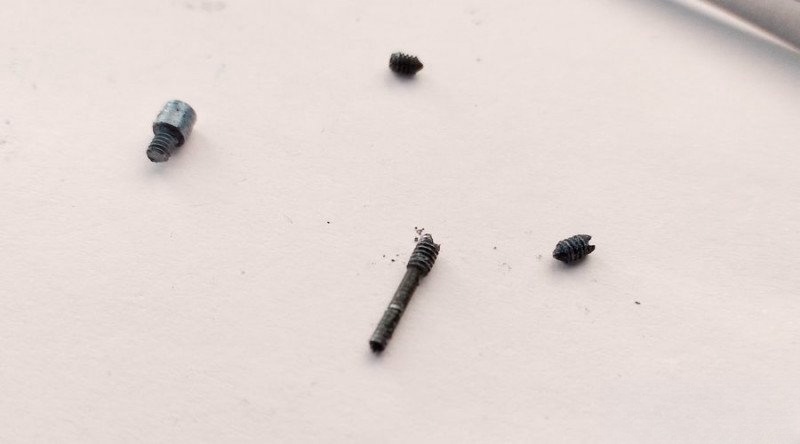 Removing long central screw from lens assembly