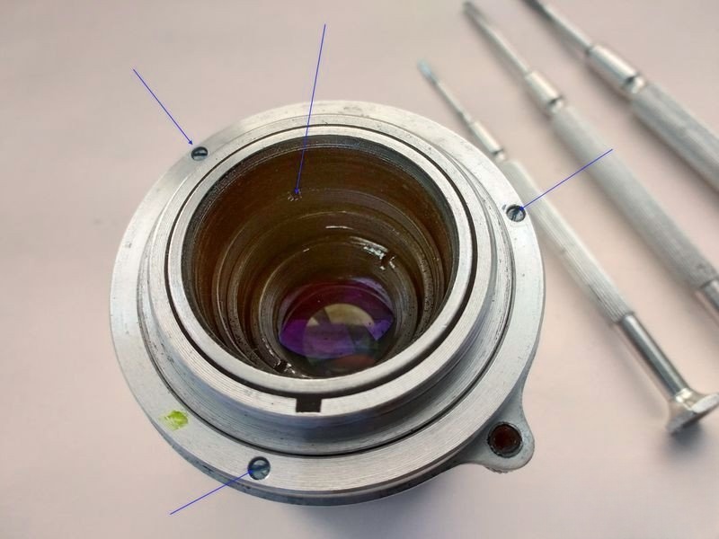 Three screws around the rangefinder cam retainer
