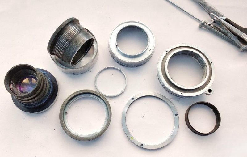 Fully disassembled Industar-26m lens with all components visible