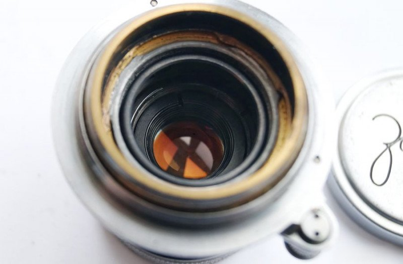 Well-preserved golden coating on rear lens element
