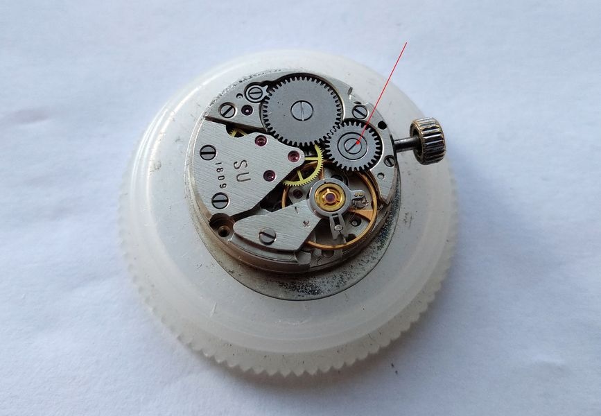 Luch 1809 in a movement holder with a red line marking the single-slotted crown wheel screw