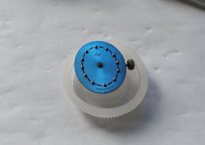 Luch 1809 movement in a holder fitted with a replacement blue dial