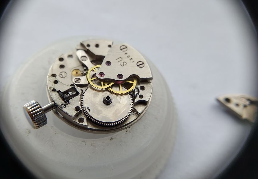 Luch 1809 with the barrel bridge removed, exposing the mainspring barrel