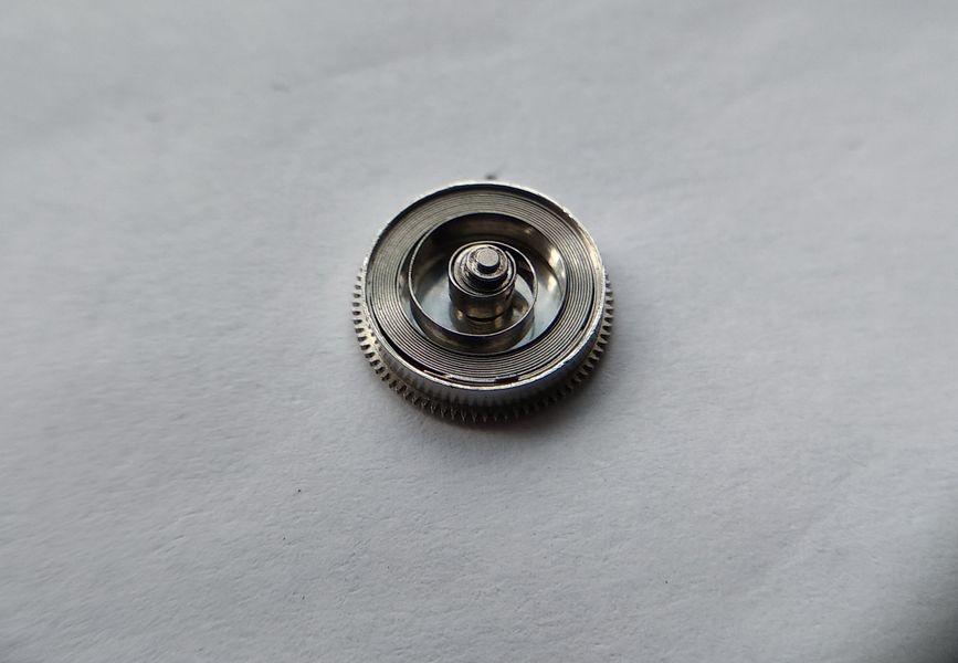 Reassembled Luch 1809 mainspring barrel showing the arbor and the coiled spring