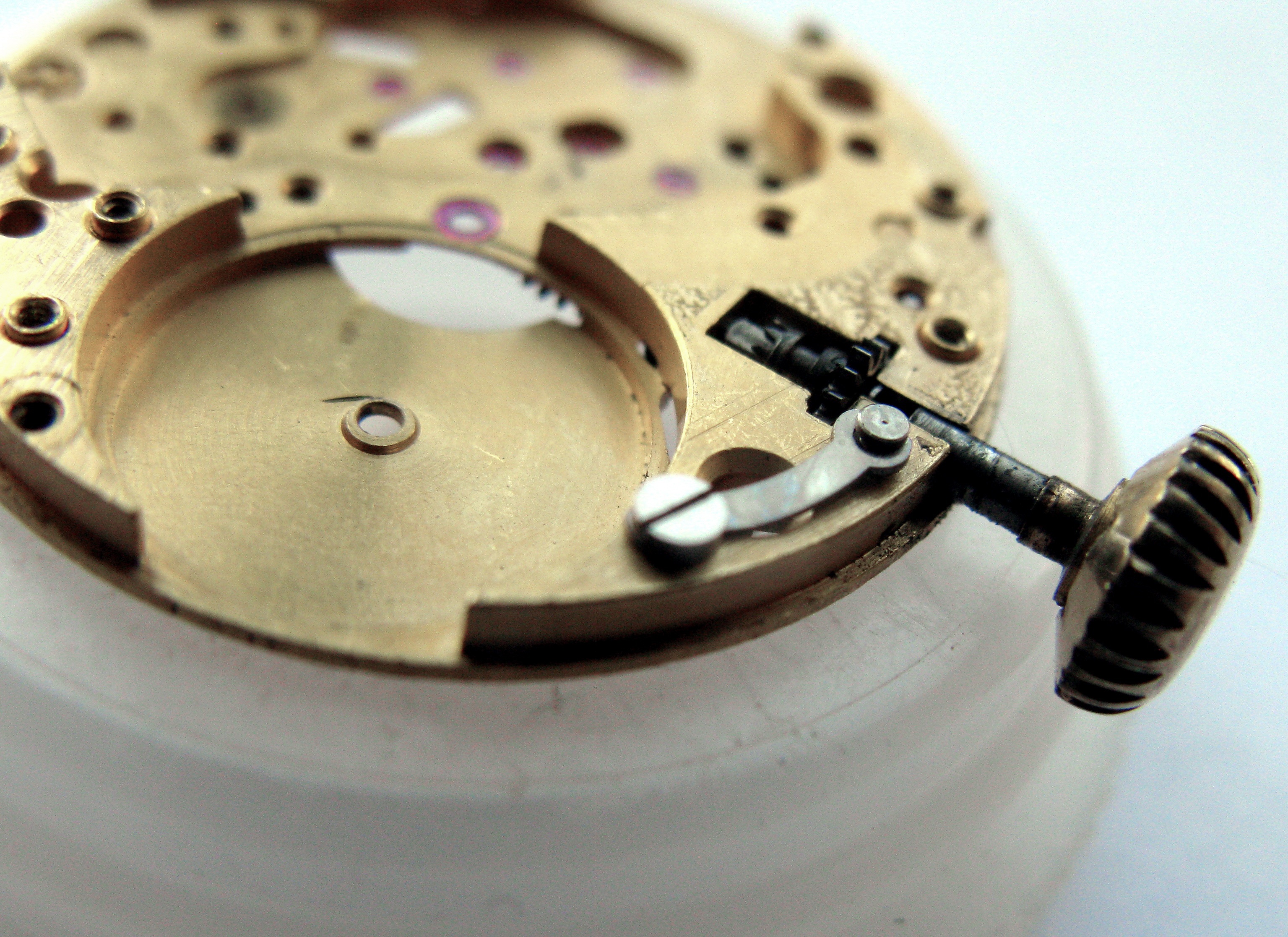 Low-angle of the keyless works showing the setting-lever spring carried on the outside of the mainplate.