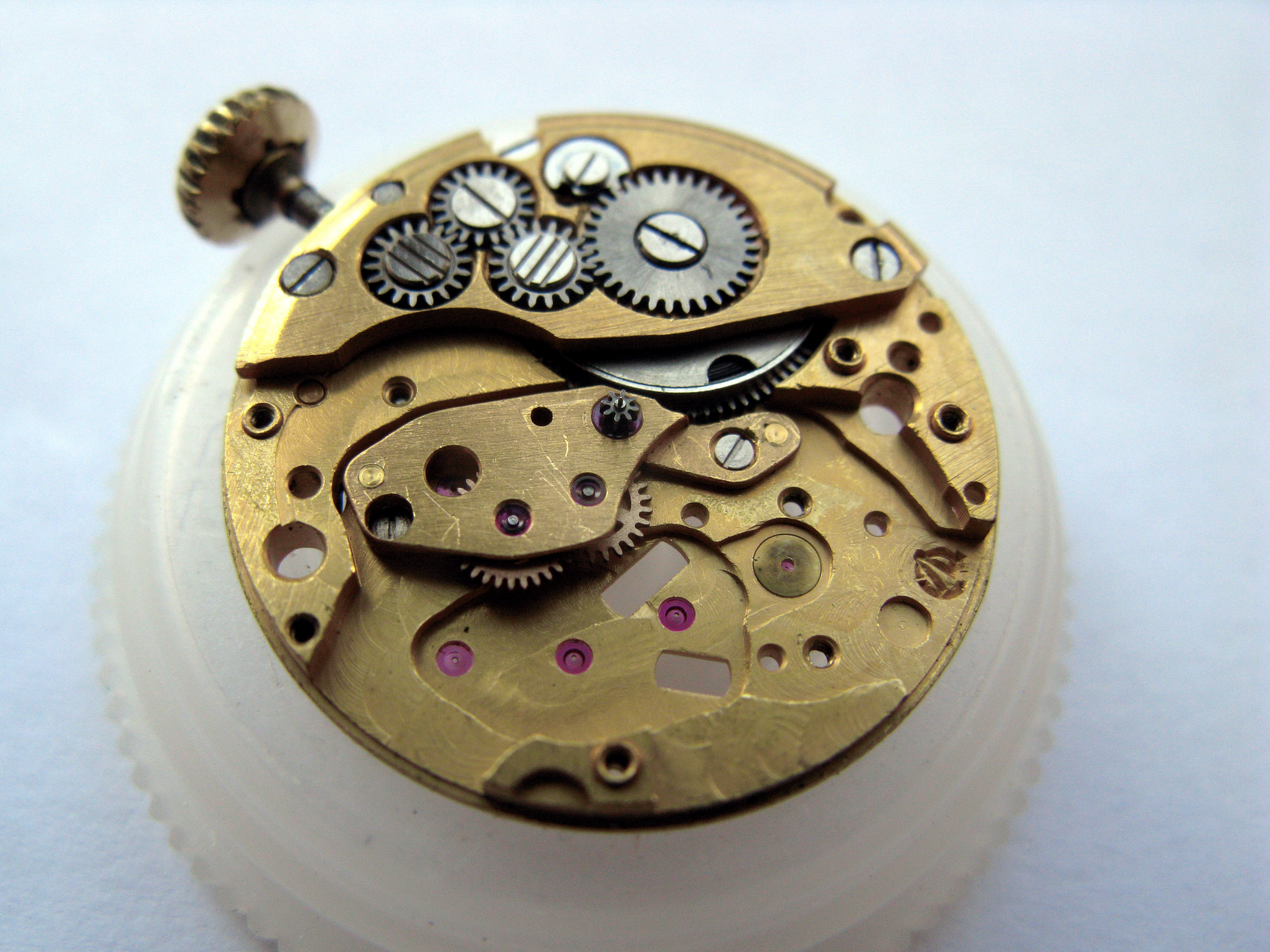 Train side with the central-wheels bridge exposed, pink jewels set into its elongated arm.