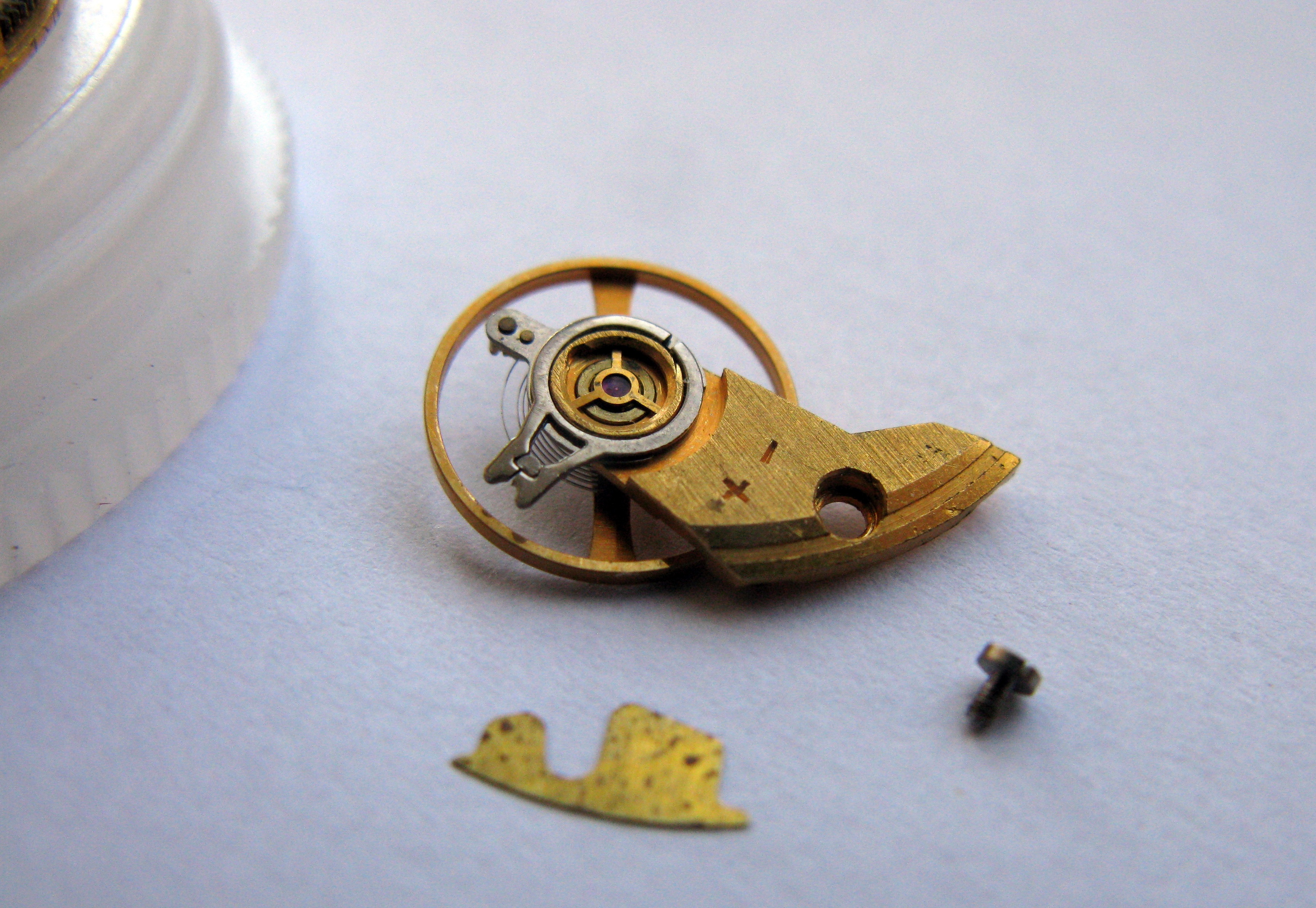 Close-up of the removed balance and cock showing the regulator and a small leaf spring.