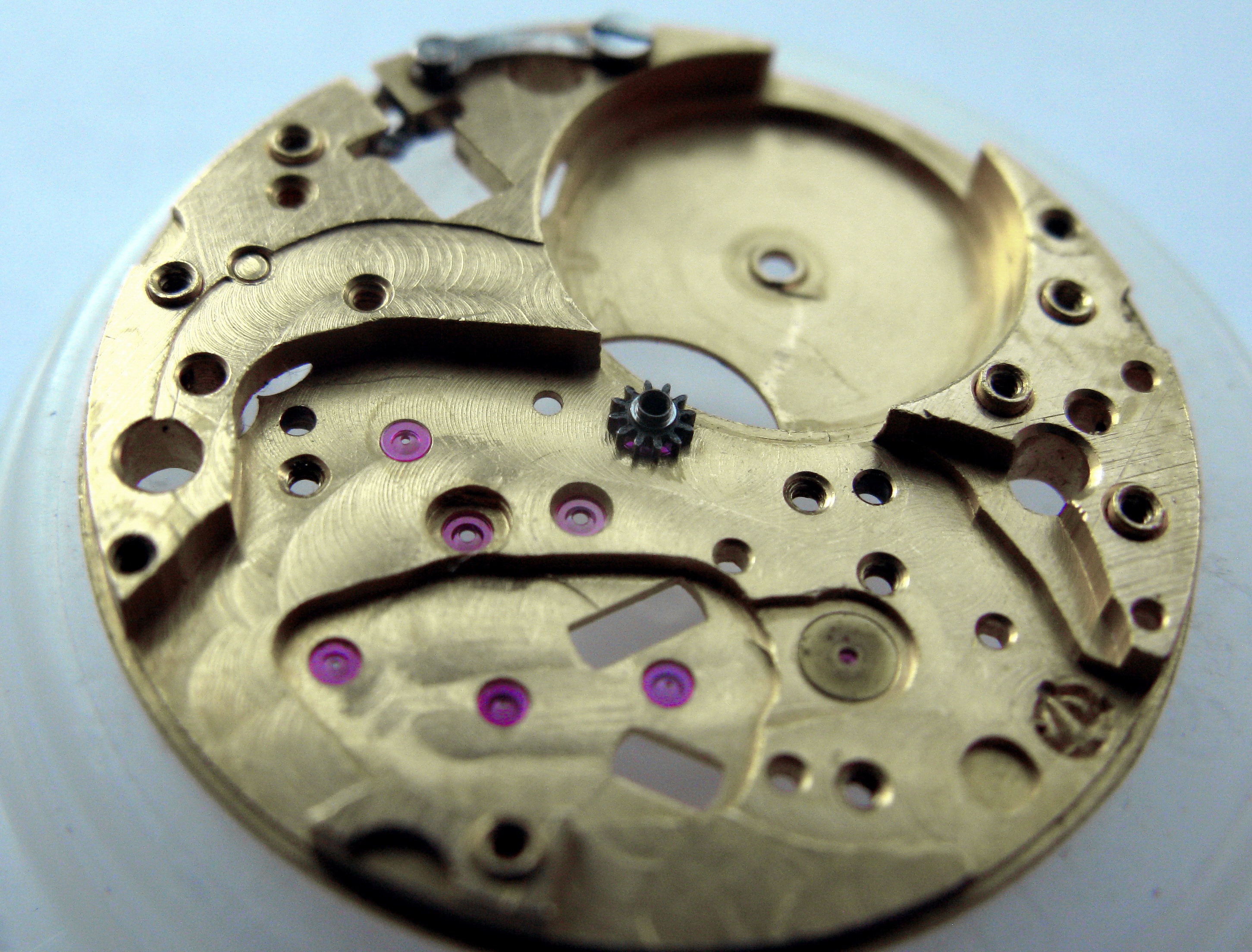The central pinion reinstalled, standing at the center of the plate.