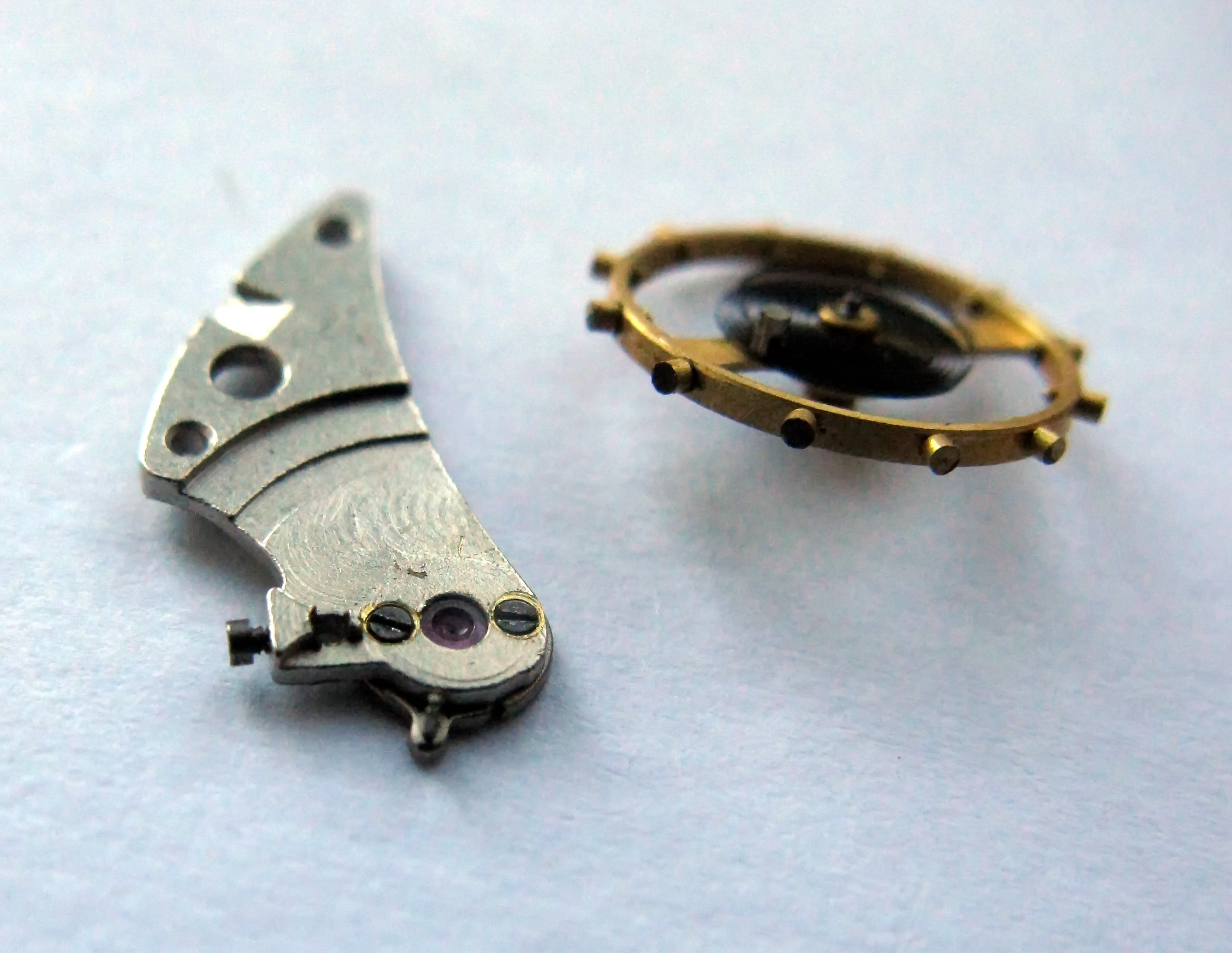 The balance wheel with its hairspring separated from the cock.