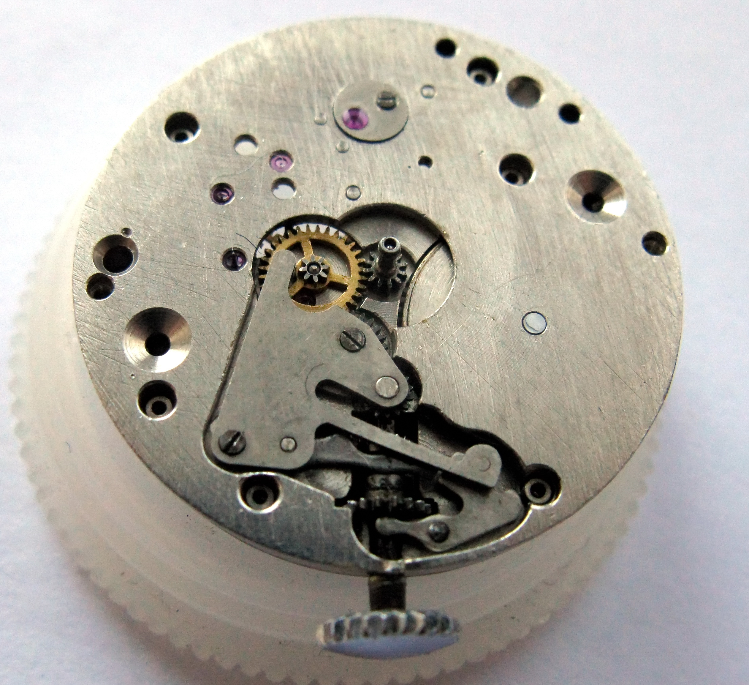 The cover plate of the keyless works being closed.