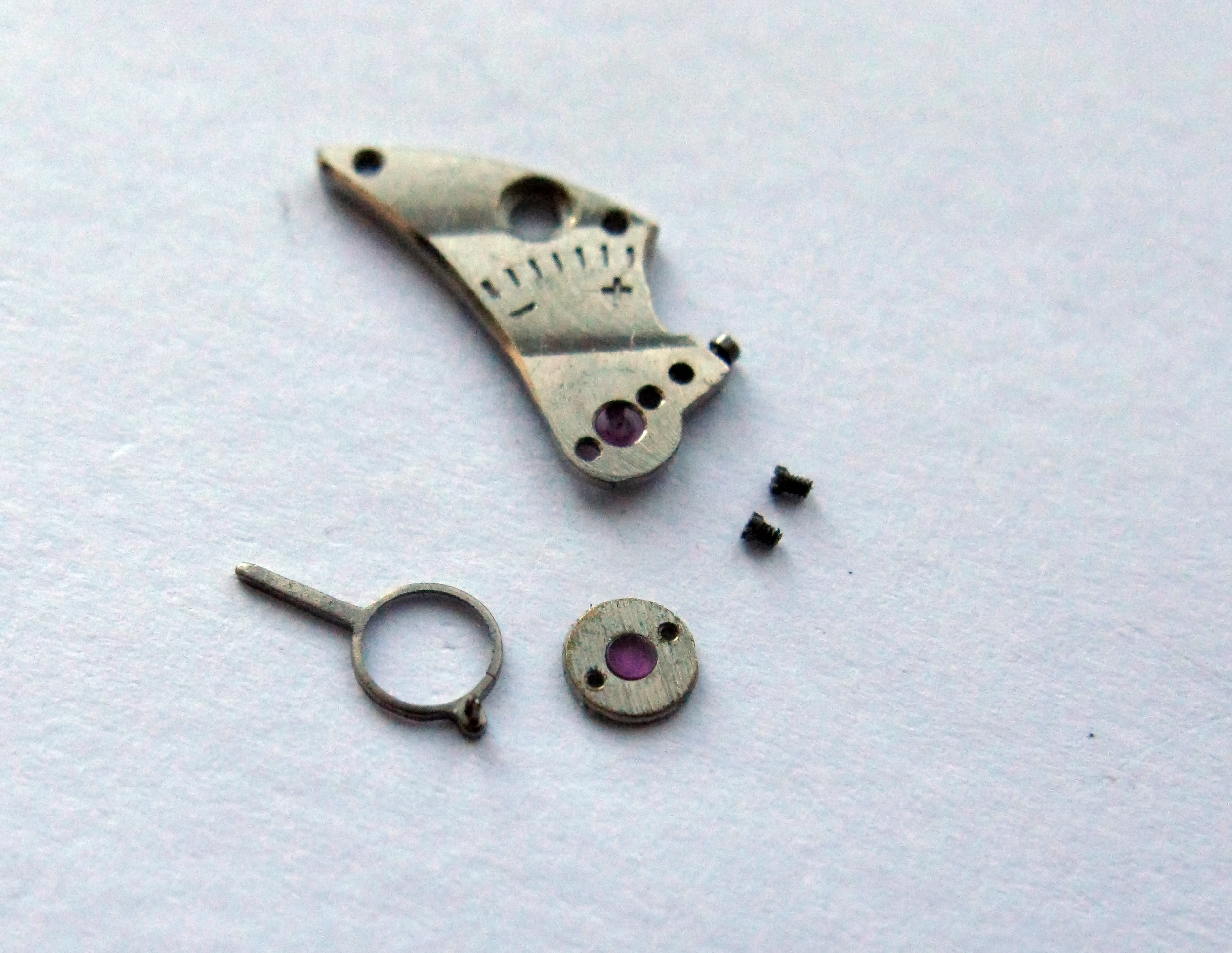The balance cock being disassembled to reach the cap jewel.