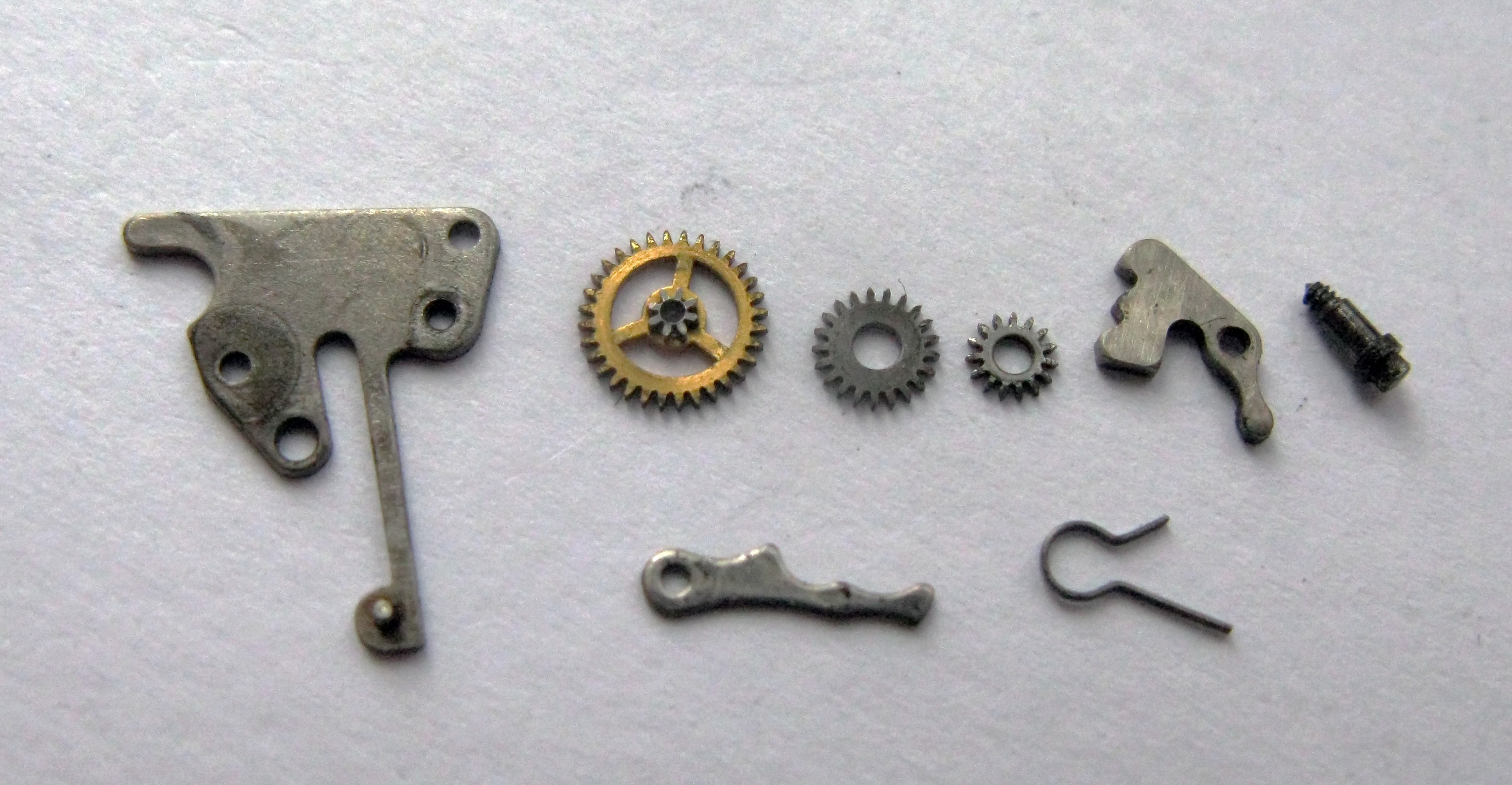 The individual components of the keyless works laid out.