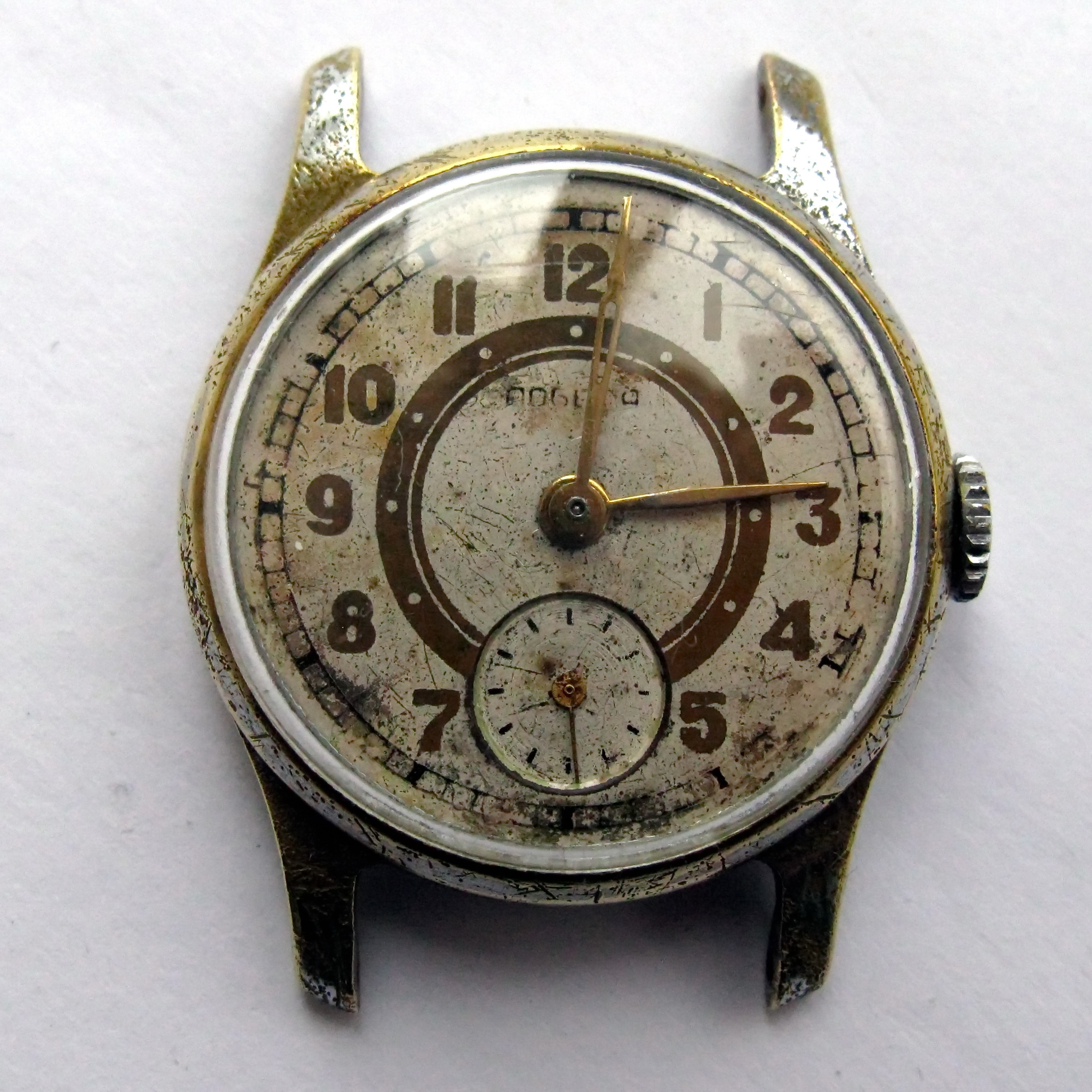 Pobeda wristwatch before disassembly, dial side, with a worn cream dial and a small seconds register at six.