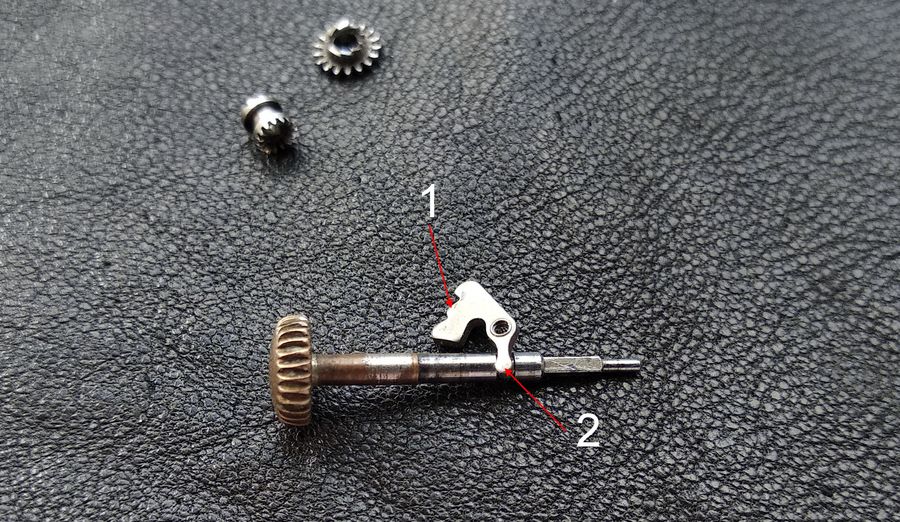 The intermediate lever, its comb and side pusher numbered one and its stem-engaging tab numbered two
