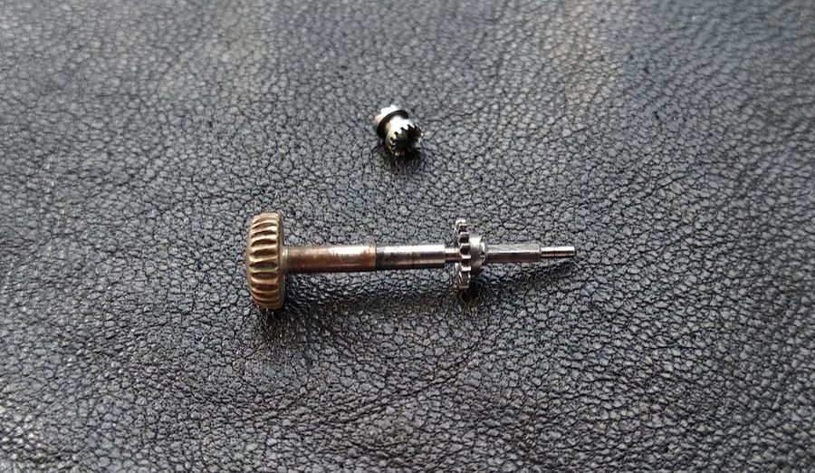 The winding pinion seated on the cylindrical shoulder of the winding stem, free to rotate