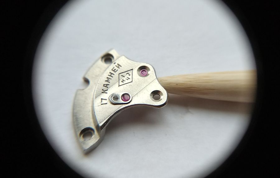 Pressing the donor jewel into the empty seconds-wheel setting of the 2609 train bridge with a wooden punch
