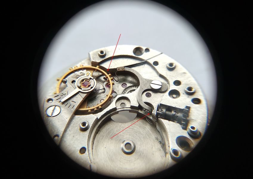 The spring finger contacting the balance wheel, stopping the balance and the watch