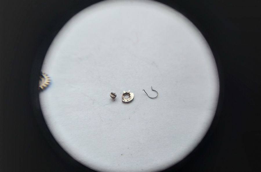 The ratchet click and its spring removed from the barrel bridge