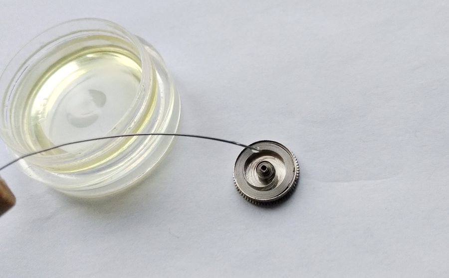 Applying Б-1 lubricant to the mainspring inside the barrel