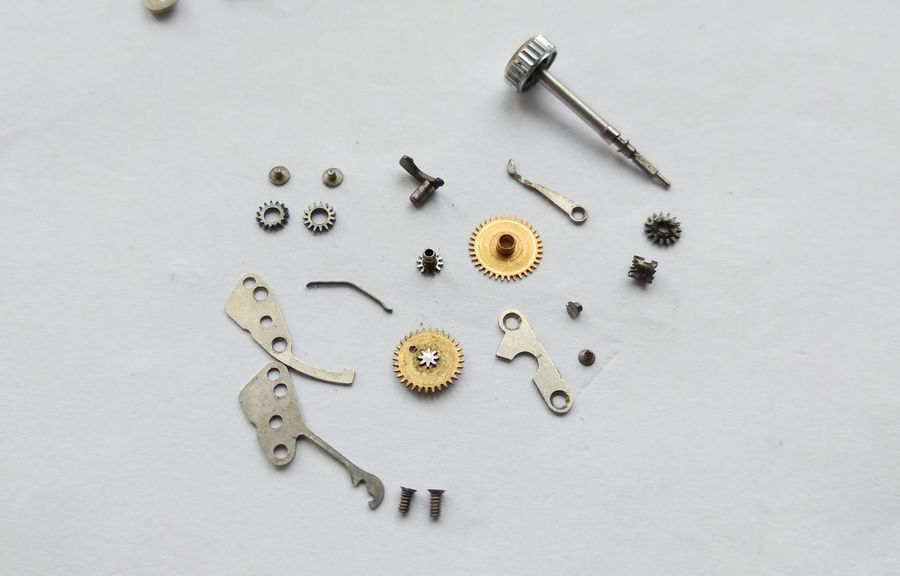 All keyless-works components including the setting-lever spring laid out together