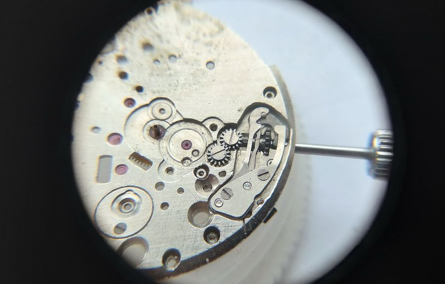 The keyless works on the dial side before disassembly, with the double spring cover in place