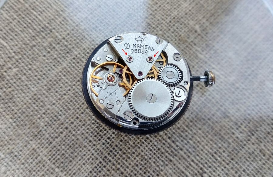 Raketa 2609A caliber showing two overlay jewels at the escapement and intermediate wheel positions, balance without timing screws