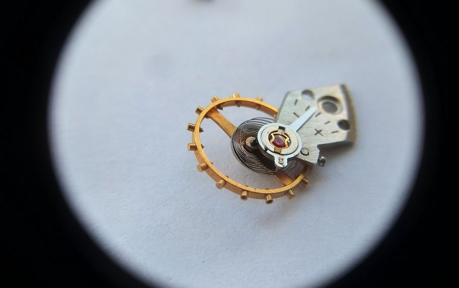 Raketa 2609B balance wheel assembly removed from the movement showing the screwed balance rim, Breguet overcoil hairspring, and Incabloc bouchon