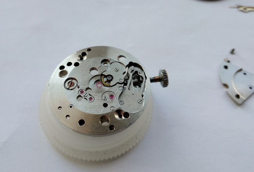 Raketa 2609B movement turned to expose the keyless works side showing the setting lever, clutch lever, and associated spring arrangement