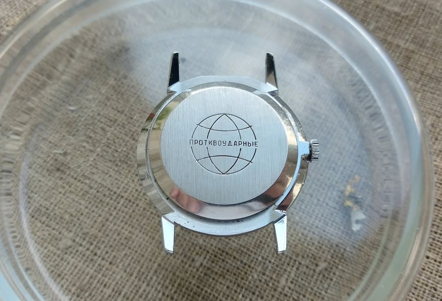 Case back of a Raketa wristwatch on caliber 2603 showing engraved text indicating shock-resistant construction