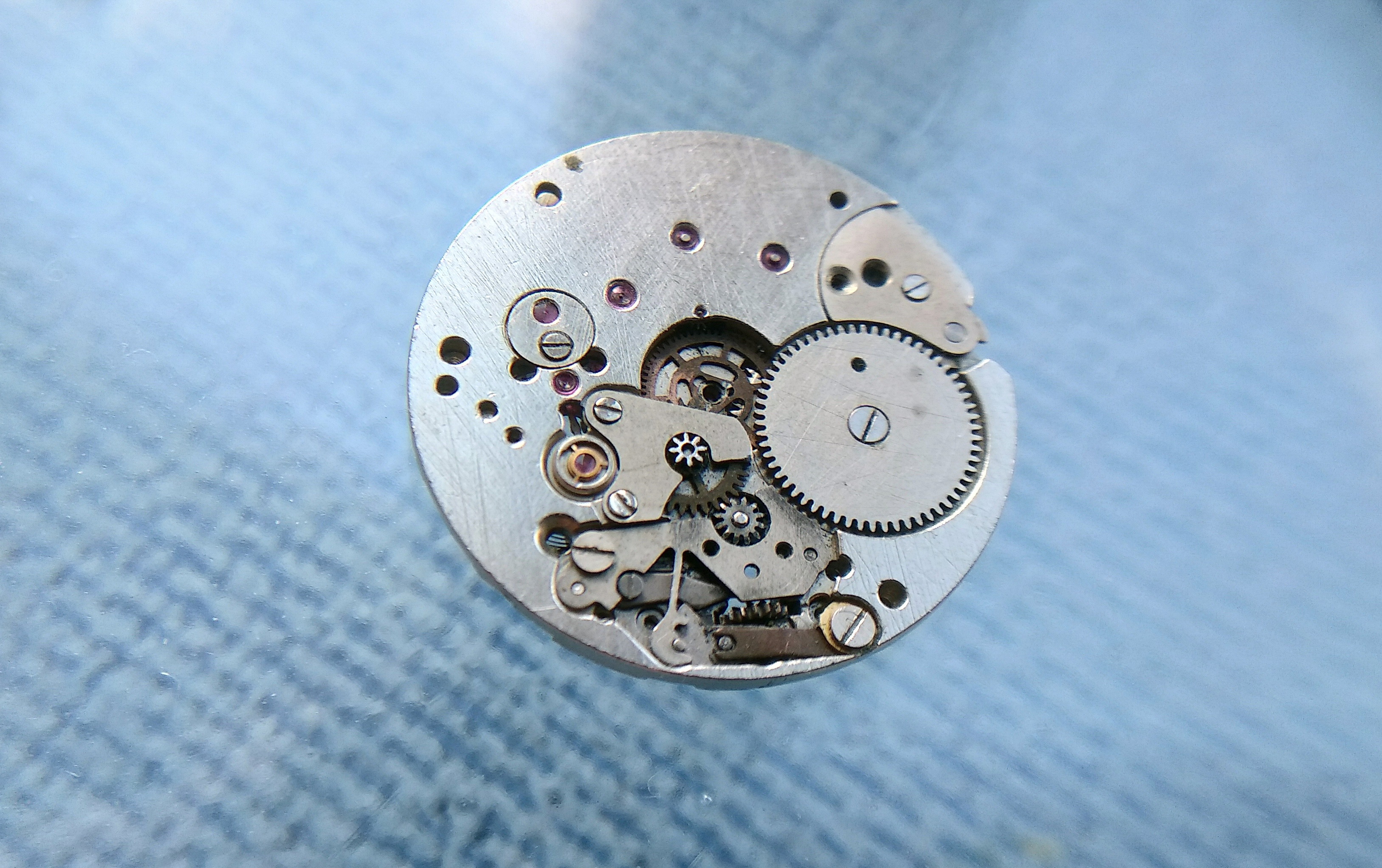 Raketa Rekord 2209 caliber viewed from the movement side, showing the ultra-thin plate architecture and the cluster of wheels under a single bridge