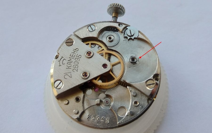 Barrel bridge of the Raketa 2609B showing the worn and ovalized pivot hole for the mainspring barrel arbor, with evidence of a previous repair attempt