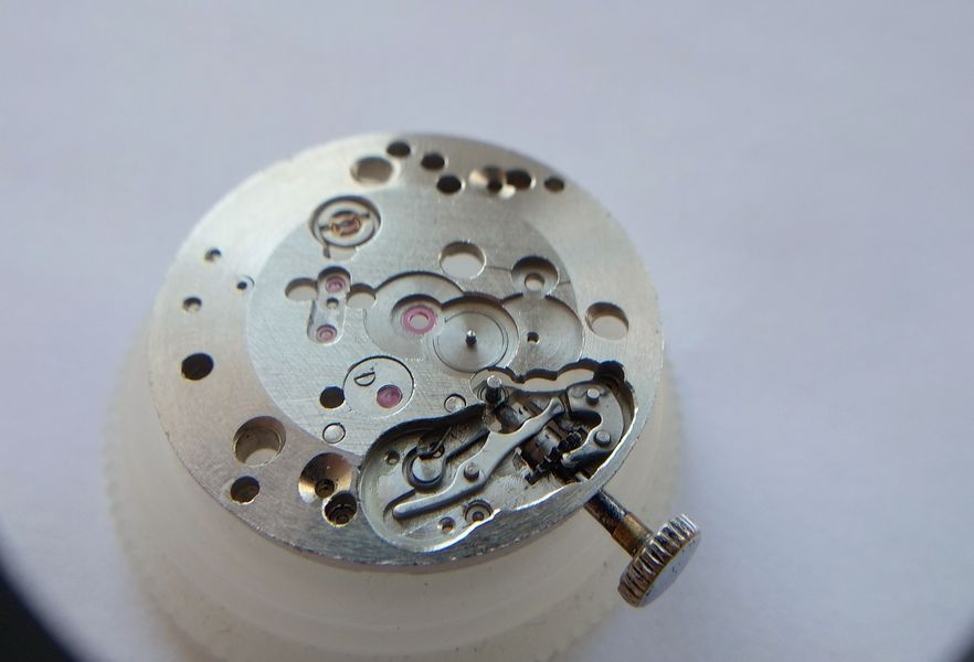 Keyless works components of the Raketa 2609B laid out after disassembly including the setting lever with its extended tail acting as a geometric limiter