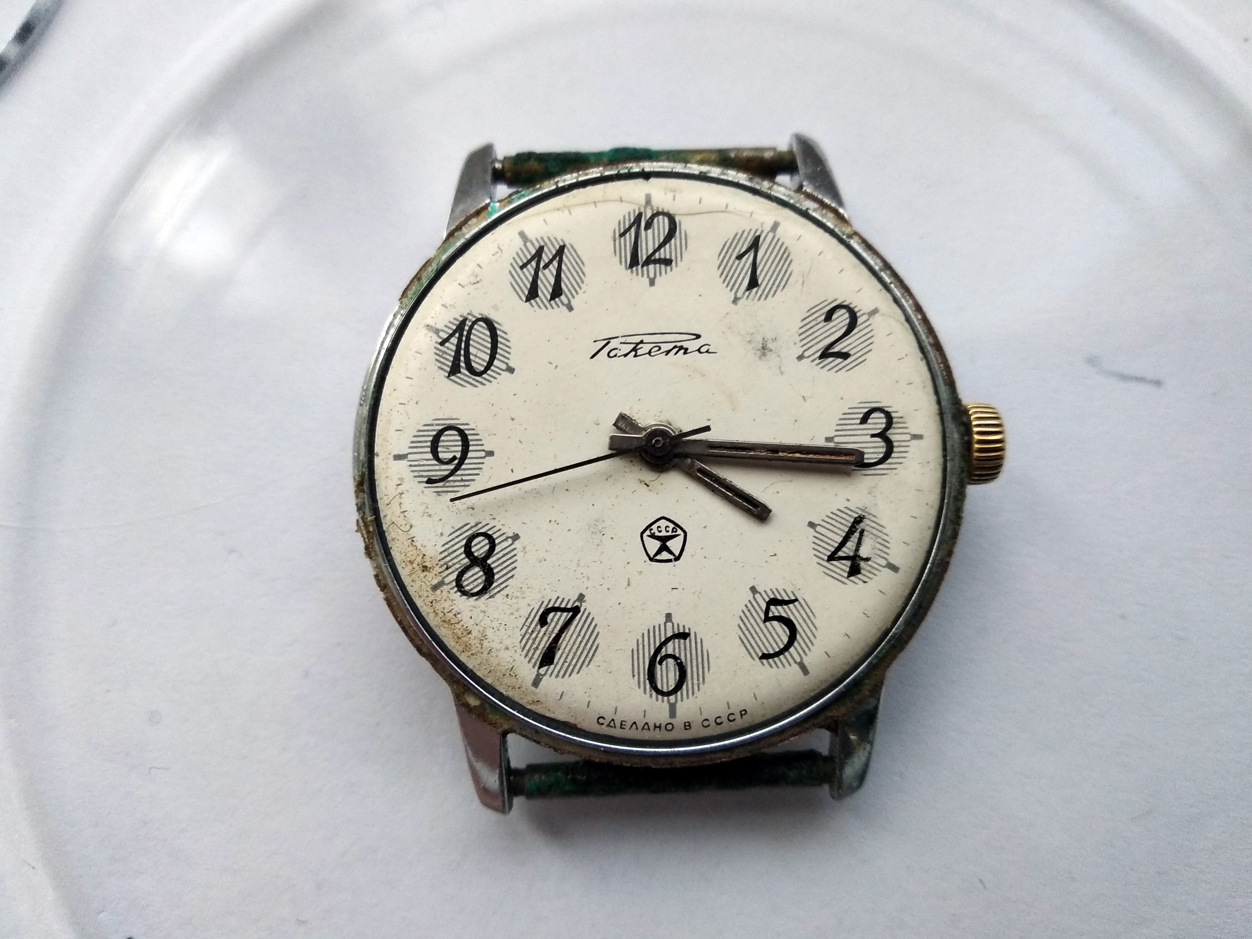 Close view of the matte white Raketa dial showing water staining and spots of rust but an intact coating
