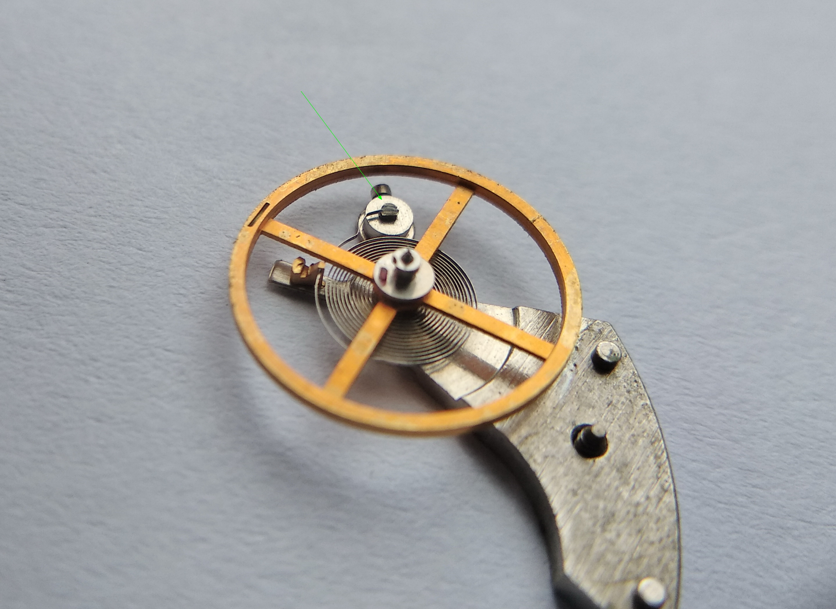 Hairspring outer end fixed to the stud with adhesive rather than a traditional pin
