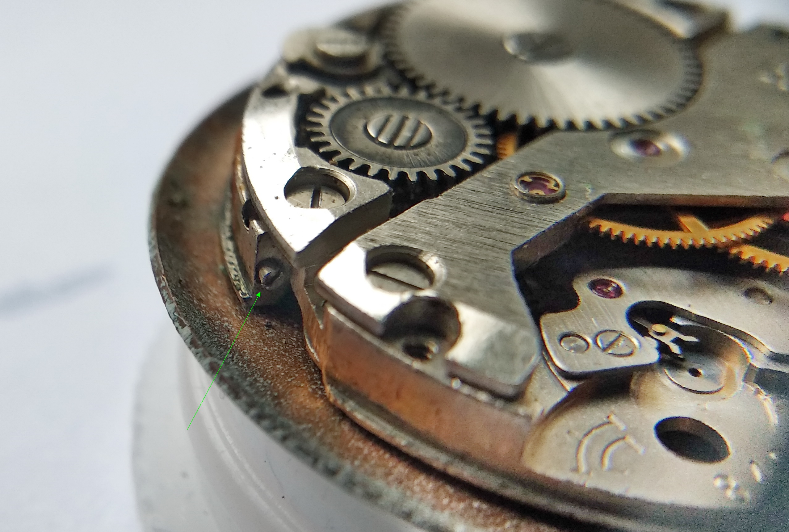 Dial-foot clamp screws set into bevels on the edge of the main plate being loosened