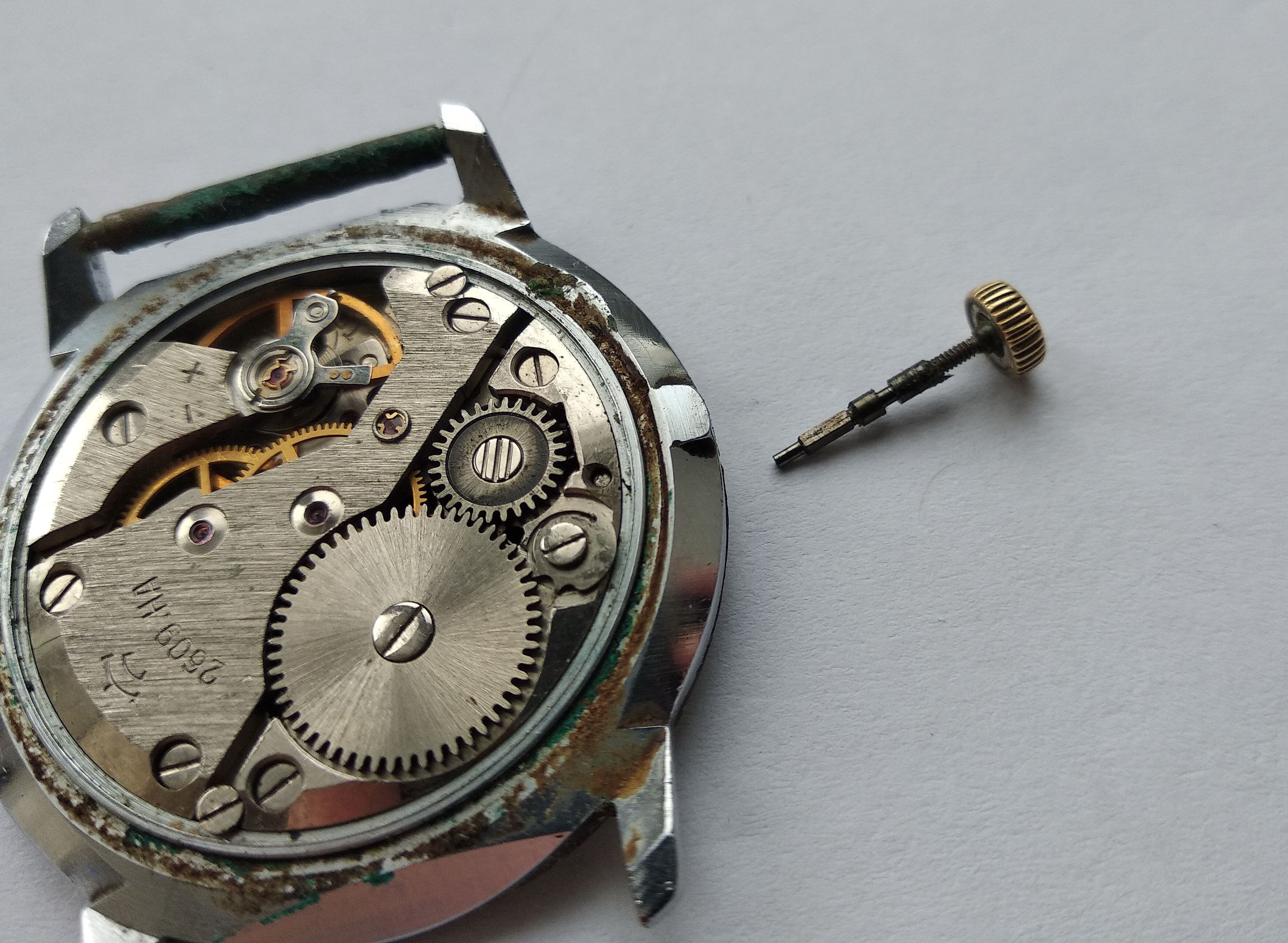 Winding stem withdrawn from the movement, coated in old hardened oil and debris