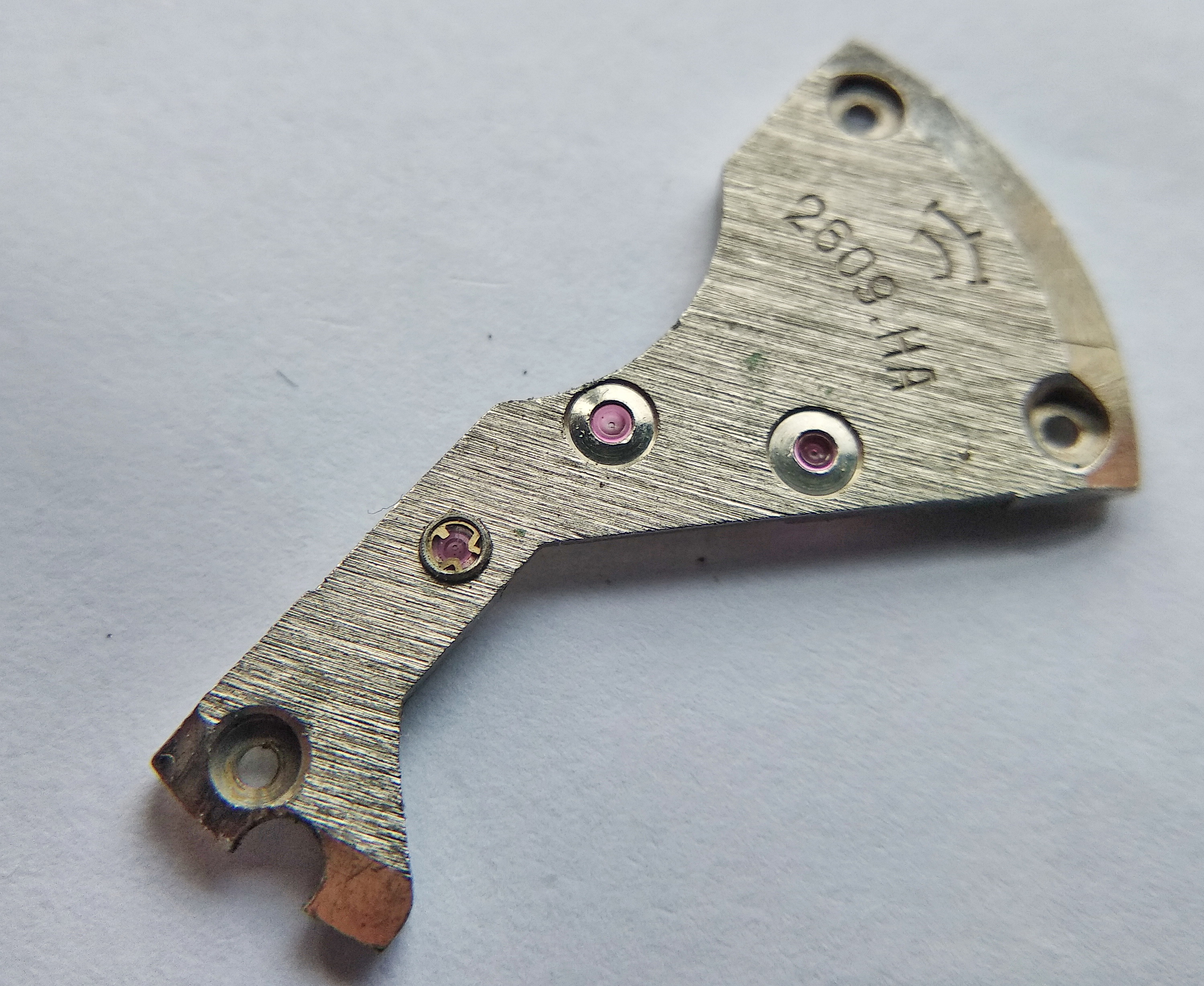 Close detail of the bridge showing the escape-wheel shock bouchon and two jeweled chatons for the train wheels