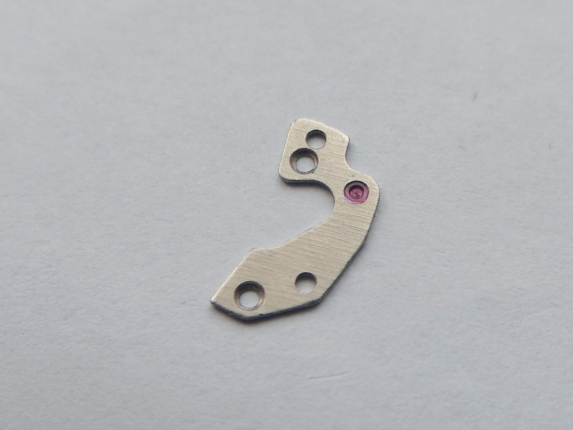 Pallet bridge with a machined oil sink in its jewel, deliberately left dry