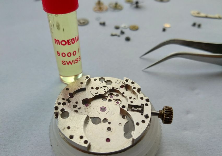 A bottle of Moebius 8000 oil beside the bare mainplate ready for the train