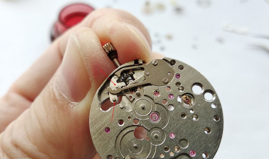 The stem drawn further out into the non-detented date-correction position, the intermediate lever finger on the cover-spring tab