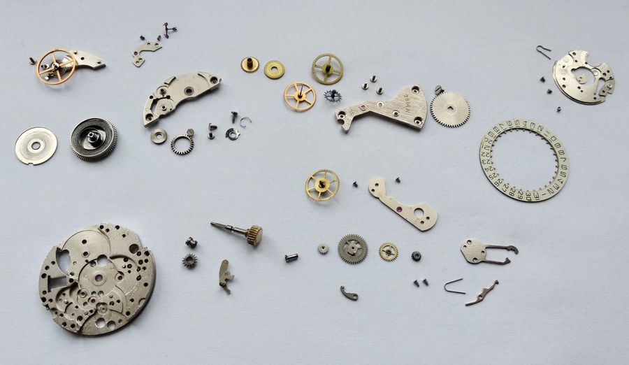 All the movement components laid out together on a work surface, fully disassembled