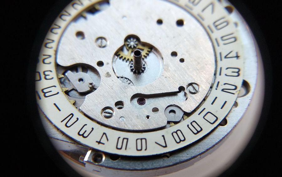 The calendar bridge being lowered over the date disc with attention to the detent lever position