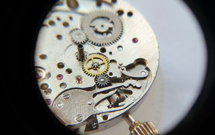 The manual date-correction lever being placed into the calendar works
