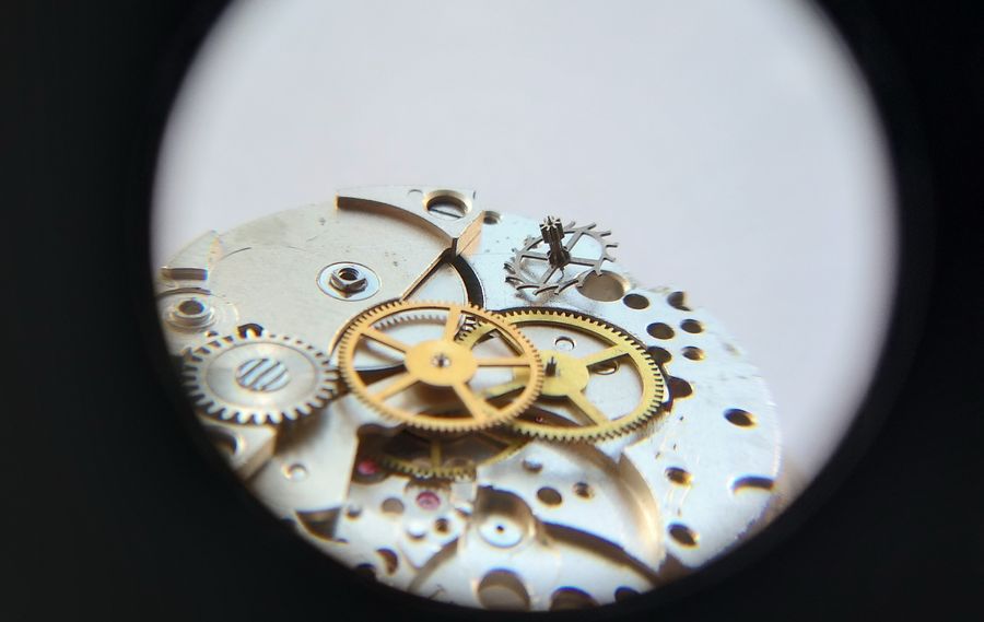 The escape wheel being placed into its pivot on the plate