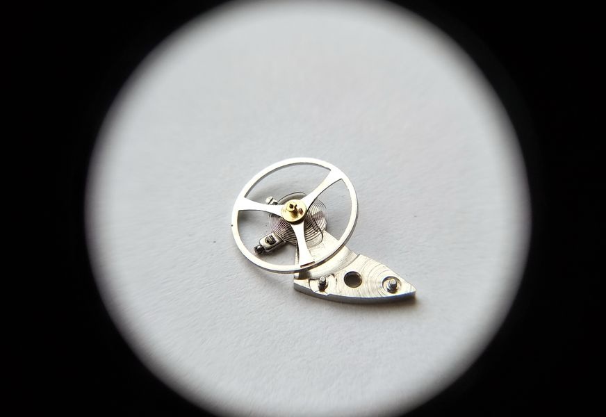 Balance wheel close-up showing double roller and impulse jewel