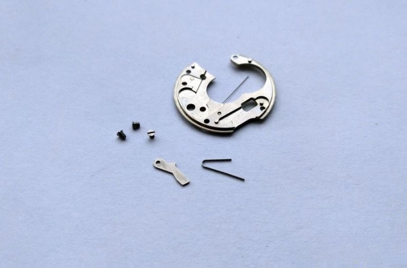 Positioning spring removed from plate
