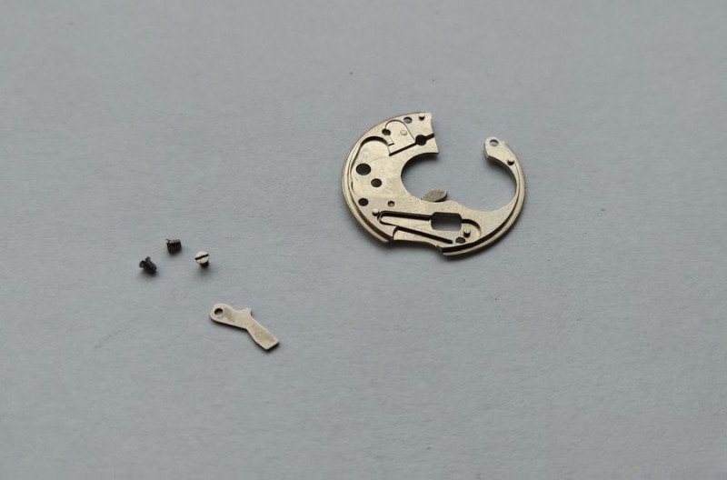 Positioning plate reverse showing milled recesses and spring