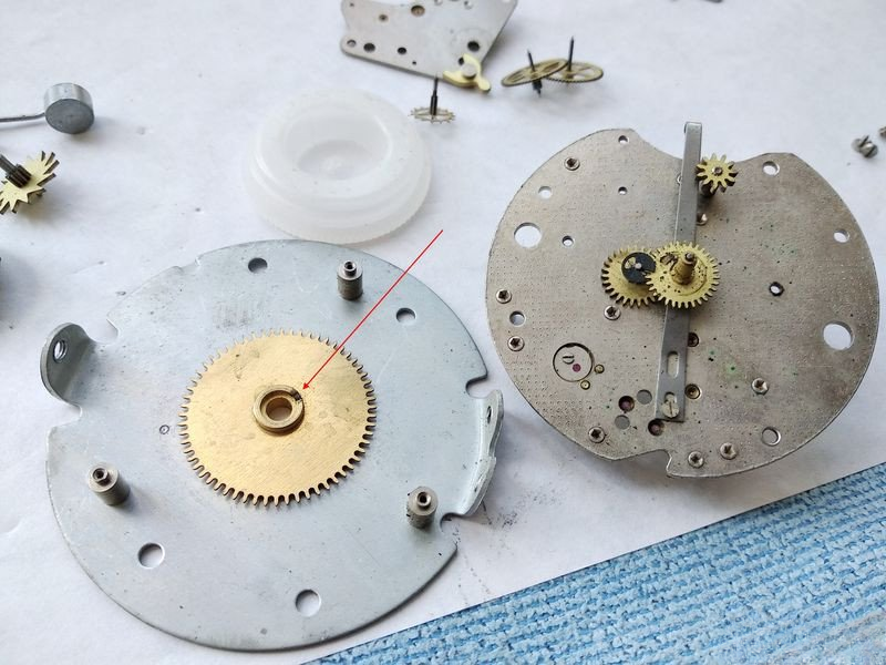 Alarm wheel plate showing slot and retaining washer