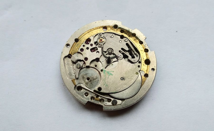 The slow side of the movement showing the accumulator spring with its beak resting on the eccentric cam