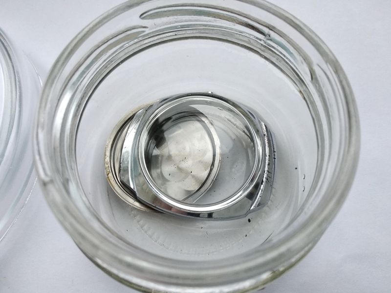 The disassembled case components soaking in benzine overnight